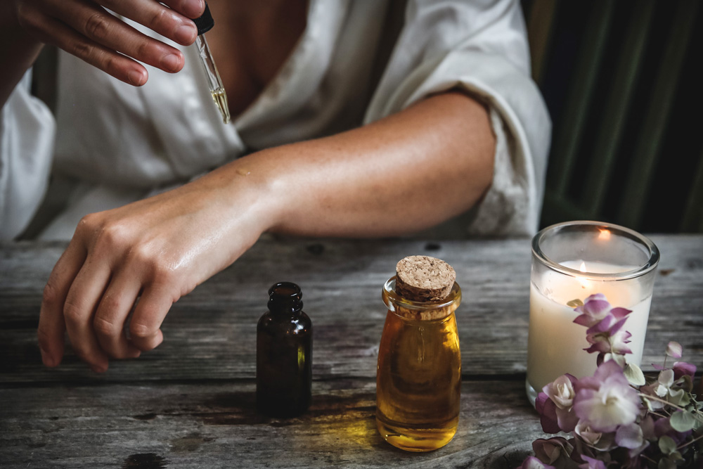 What Is Ayurveda and How Can It Benefit You? by Sweta Vikram. Photograph of oils and candle by Chelsea Shapouri