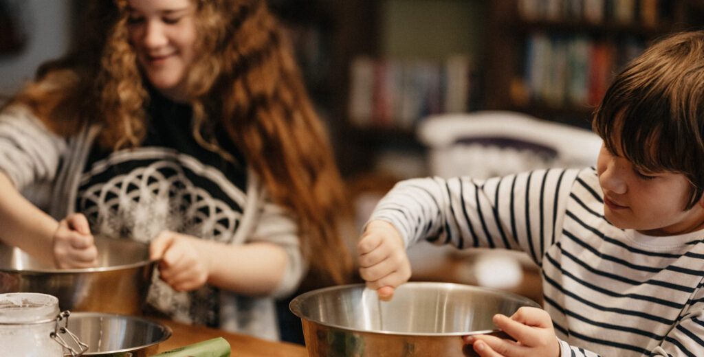 Cooking with Kids: Tips to Engage Your Children in the Art and Joy of Food, by Maria Lawrence. Photograph of kids cooking by Annie Spratt