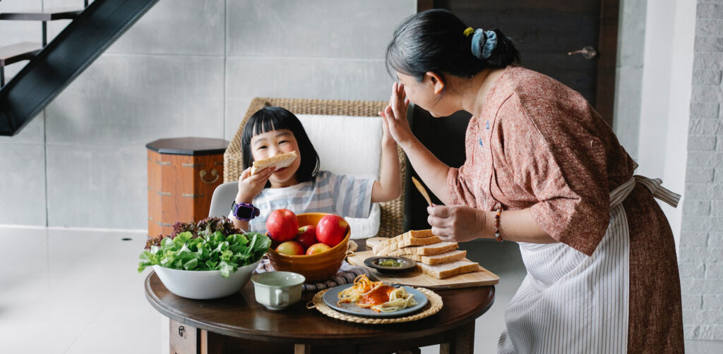 Nurturing Self-Care in Kids: Activities for Resetting, Refreshing, and Preparing, by Anya Willis. Photograph of mother and child eating by Alex Green