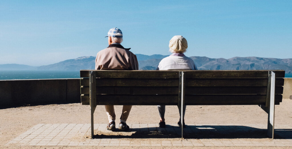 Loving Life Now: A Survival Guide for Aging…and Actually Enjoying It, by Solomon Stevens. Photograph of older couple on bench by Matt Bennett