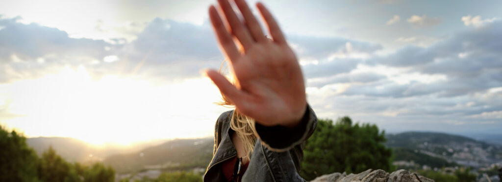 Buried Alive: How Disconnecting with my Mother Finally Freed Me, by BrideyThelenHeidel. Photograph of hand blocking woman's face by Philipp Wuthrich