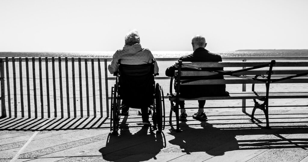 The Senior Manifesto: A Guide for (Mostly) Graceful Aging, by Jane Seskin. Photograph of older couple on bench facing water by Bruno Aguirre