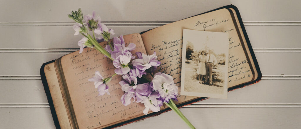 More than Gratitude: A Generational Legacy from War-Era to Modern Family, by Diana Raab. Photograph of vintage journal and photograph with flower on top by Debby Hudson