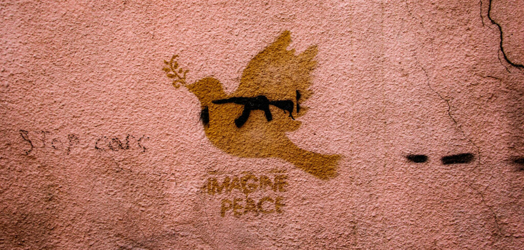 Inner Peace: The Basis of World Peace, by Barbara Ann Briggs. Photograph of wall art of a dove overlayed atop a gun, by Zaur Ibrahimov