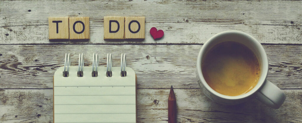 lay flat stillife of note pad, coffee and a to do list
