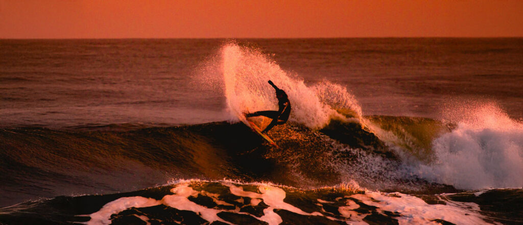 Surfer at sunset, learning to express emotions and healthy masculinity